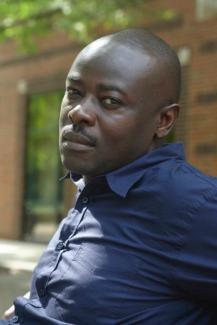 Picture of author Helon Habila sitting outside